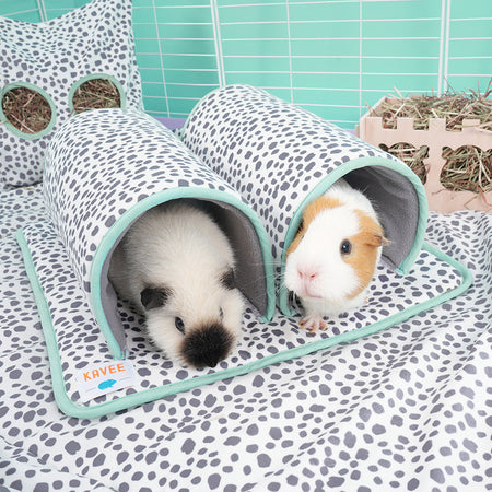 Two guinea pigs in Kavee's dalmatian print double tunnel. On dalmatian fleece liner with white haybag and a haybox in background in white c&c cage