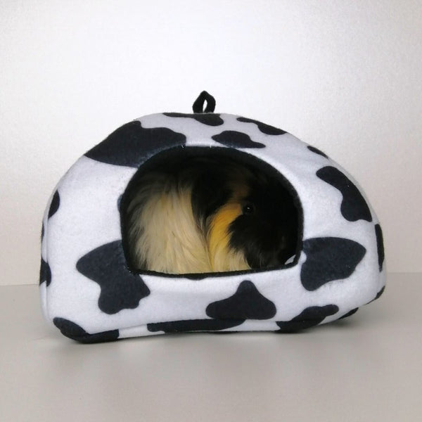 a guinea pig using a hidey house made of cowprint fleece by kavee