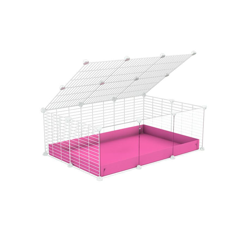 A 2x3 C and C cage with clear transparent plexiglass acrylic grids  for guinea pigs with pink coroplast a lid and small hole white grids from brand kavee